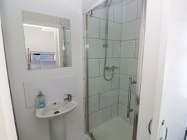 A bathroom with a shower and sink at 3 Edward Street in Tenby