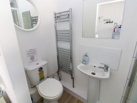 A bathroom with a toilet and sink at 3 Edward Street Tenby