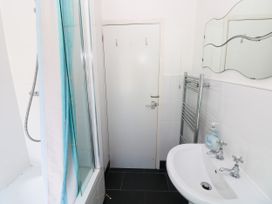 A bathroom with a bathtub and shower at 3 Edward Street Tenby
