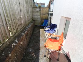 An outdoor area with chairs and a gravel surface at 3 Edward Street Tenby