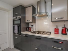 A kitchen with a gas stove and appliances at 30 Prospect Hill, Whitby