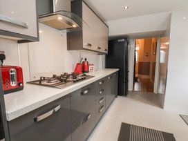 A kitchen with a gas stove and fridge at 30 Prospect Hill, Whitby