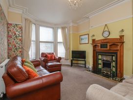 A living room with a sofa and armchair at 30 Prospect Hill in Whitby