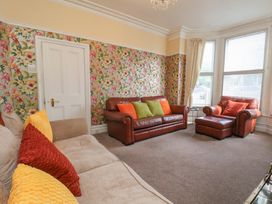 A living room with a sofa and armchair at 30 Prospect Hill in Whitby
