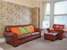 A living room with a sofa and armchair at 30 Prospect Hill in Whitby