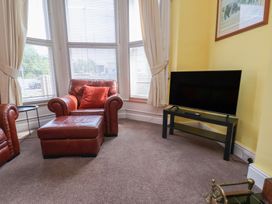 A living room with a television and an armchair at 30 Prospect Hill Whitby