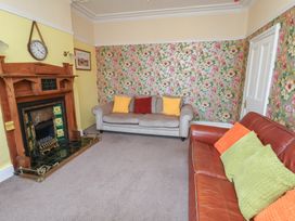 A living room with a fireplace and seating at 30 Prospect Hill Whitby