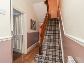 A hallway with a staircase and doors at 30 Prospect Hill Whitby