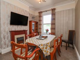 A dining room with a table and chairs at 30 Prospect Hill in Whitby