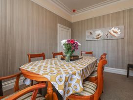 A dining room with a table and chairs at 30 Prospect Hill in Whitby