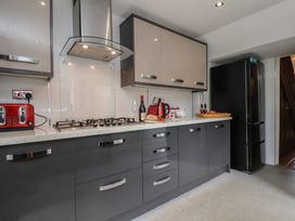 A kitchen with cabinets, stove, refrigerator, and kitchenware at 30 Prospect Hill Whitby