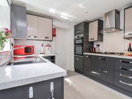 A kitchen with a sink, microwave, and oven at 30 Prospect Hill, Whitby