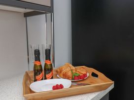 A kitchen with a tray containing drinks, glasses, croissants, and raspberries at 30 Prospect Hill, Whitby