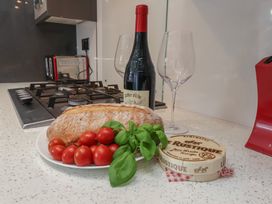 A kitchen with bread, wine, glasses, and cheese at 30 Prospect Hill, Whitby