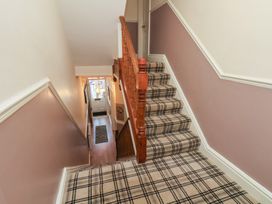 A staircase leading to a landing at 30 Prospect Hill in Whitby
