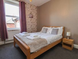 A bedroom with a bed and bedside table at 30 Prospect Hill in Whitby