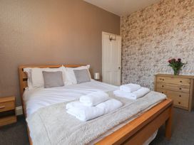 A bedroom with a bed and dresser at 30 Prospect Hill in Whitby
