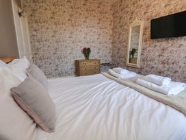 A bedroom with a bed and dresser at 30 Prospect Hill, Whitby