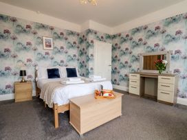A bedroom with a bed, nightstand, and dresser at 30 Prospect Hill in Whitby