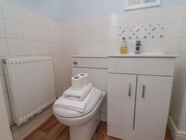 A bathroom with a toilet and sink at 30 Prospect Hill in Whitby