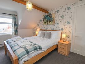 A bedroom with a bed and bedside table at 30 Prospect Hill in Whitby