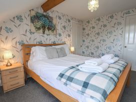 A bedroom with a bed and bedside table at 30 Prospect Hill in Whitby