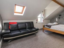 An attic room with a sofa and bed at 30 Prospect Hill, Whitby