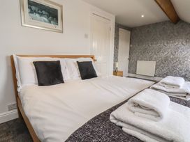 A bedroom with a bed and towels at 30 Prospect Hill in Whitby