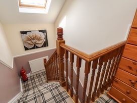A staircase with a skylight and a wooden railing at 30 Prospect Hill in Whitby