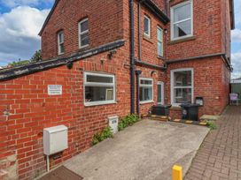 An outdoor area with brick walls, parking space, and bins at 30 Prospect Hill, Whitby