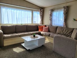 A living room with a sofa and coffee table at St Osyth- Sleeps8-freeparking-wifi-holidaypark in Clacton-On-Sea