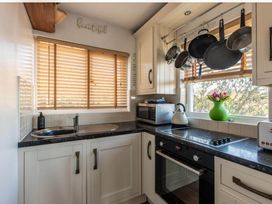 A kitchen with a sink, kettle, and pots at 1 Bed Flat - Sleeps 2 - Pets - Balcony - Parking in Looe