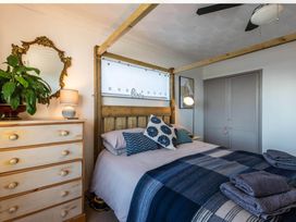 A bedroom with a bed and bedside lamp at 1 Bed Flat - Sleeps 2 - Pets - Balcony - Parking in Looe