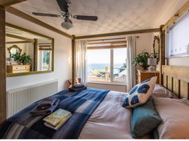 A bedroom with a bed and a window with a view at 1 Bed Flat - Sleeps 2 - Pets - Balcony - Parking in Looe