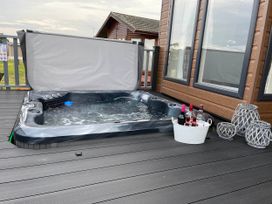 A hot tub with a bucket of drinks at Yorkshire view lodge Wilberfoss