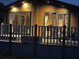 A deck with outdoor furniture at Yorkshire view lodge in Wilberfoss