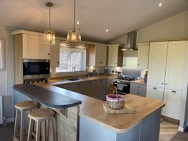 A kitchen with appliances and an island at Yorkshire view lodge in Wilberfoss
