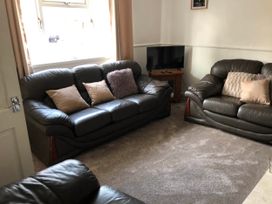 A living room with sofas and a television at 3 Bed House - Sleeps 6 - Parking - Garden - Wifi Glynneath