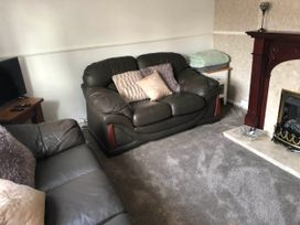 A living room with a sofa and television at 3 Bed House - Sleeps 6 - Parking - Garden - Wifi Glynneath