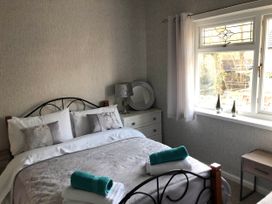 A bedroom with a bed and a window at 3 Bed House - Sleeps 6 - Parking - Garden - WIfi in Glynneath