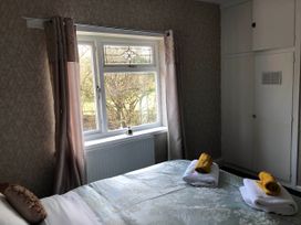 A bedroom with a bed and window at 3 Bed House - Sleeps 6 - Parking - Garden - WIfi Glynneath