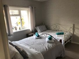 A bedroom with two beds and towels on them at 3 Bed House - Sleeps 6 - Parking - Garden - Wifi Glynneath
