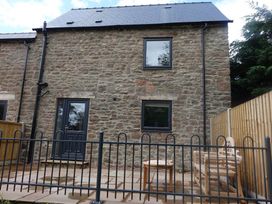 A stone building with windows and a doorway in an outdoor area at Cottage - Sleeps 2 - Garden in Coleford