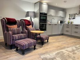 A kitchen with two armchairs and an ottoman at Cottage - Sleeps 2 - Garden in Coleford