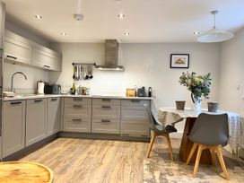 A kitchen with sink and table at Cottage - Sleeps 2 - Garden in Coleford