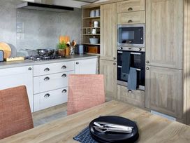 A kitchen with cabinets and oven at 2 Bed Lodge Sleeps 4 - Pet Welcome - Fireplace Cirencester