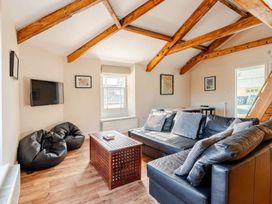 A living room with a sofa and coffee table at Sedbergh Penthouse - KingBed - Tv - Wifi Sedbergh