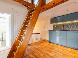 A kitchen with staircase and cabinets at Sedbergh Penthouse - KingBed - Tv - Wifi in Sedbergh