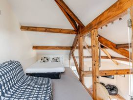 A loft with a bed and sofa at Sedbergh Penthouse - KingBed - Tv - Wifi, Sedbergh
