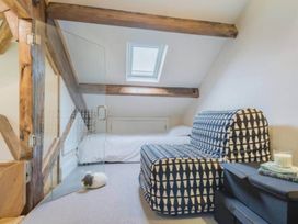A loft area with a sofa bed and bed at Sedbergh Penthouse - KingBed - Tv - Wifi Sedbergh